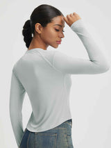 Light grey Baleaf UPF 50+ long-sleeve crop shirt with crew neck and slim fit, shown on a woman. #color_Light Gray