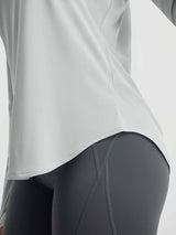 Baleaf light grey UPF 50+ long-sleeve shirt curved hem detail with dark grey leggings. #color_Light Gray