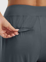 Petite ankle length pull-on travel pants in charcoal, showing pocket detail. #color_Dark Gray