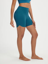 Teal Baleaf stretchy 5" high-rise biker shorts with curved hem. #color_Deep Blue