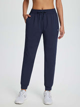 Women's navy drawstring fleece jogger pants with elastic waist and cuffed ankles. #color_Navy Blue