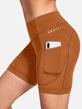 Women's terracotta V-waist cycling shorts with side phone pocket and reflective dots. #color_Brown