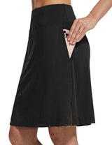 Black golf skort with side pocket holding phone, ideal for outdoor comfort. #color_Black