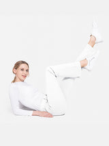 White flared yoga work pants on a model, showcasing professional design and flexibility.