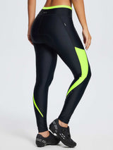 Women's padded colorblock cycling tights in black with neon green accents and reflective dots. #color_Fluorescent Green