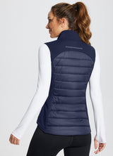 Back view of women's navy running slim-fit puffer vest with quilted front and reflective yoke. #color_Navy Blue