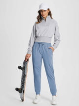 Women's light blue drawstring fleece-lined jogger pants, holding skateboard. #color_Light Blue
