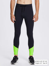 Men's black fleece lined running tights with lime green ankle panels.