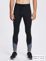 Men's black fleece lined running tights with grey ankle color-block, drawstring, and zippered ankles.