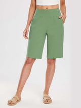 Woman wearing light green 12" cotton bermuda shorts with an elastic waistband and pockets. #color_Green