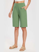 Woman wearing light green 12" cotton Bermuda shorts with an elastic waistband and pockets. #color_Green