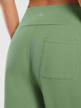Woman in light green 12" cotton Bermuda shorts with elastic waistband and back pocket #color_Green