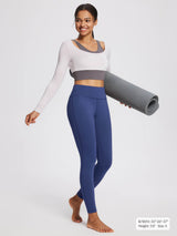 Women's petite blue fleece-lined yoga leggings, high waist, holding yoga mat.