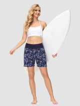 Women's 5-inch blue floral print quick-dry swim board shorts with high waist, posing with surfboard. #color_Print 2