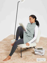 Woman wearing light grey sleeveless fleece thermal dress with quarter zip.