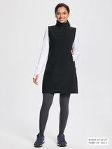 Black fleece thermal sleeveless dress with quarter-zip, side pockets, styled for outdoor activities.