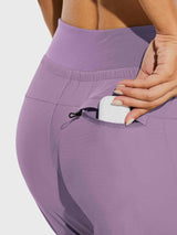 Women's tall high-waisted purple hiking joggers with zippered pocket. #color_Purple