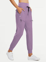 Women's purple quick-dry hiking joggers, high-waisted, with zip pockets and drawstring.
