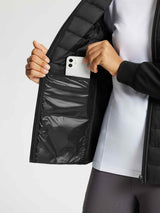Woman placing smartphone into inner pocket of black quilted outdoor jacket #color_Black