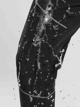 Black fleece mountain pants with water splashing to highlight water-repellent outer. #color_Gray