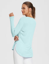 Light blue UPF 50+ long sleeve shirt with thumb holes and side slits, worn by a woman. #color_Spa Retreat