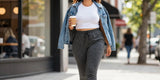 Stylish curvy woman walking in city wearing comfortable curvy fit joggers and denim jacket