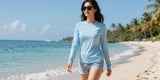 Woman relaxing on tropical beach wearing stylish womens upf 50 tops for sun protection