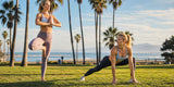 Two women comparing yoga leggings and running leggings during an outdoor morning fitness workout.