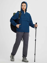 Blue packable 1/4 zip windbreaker jacket on woman with backpack and trekking pole #color_Navy Blue