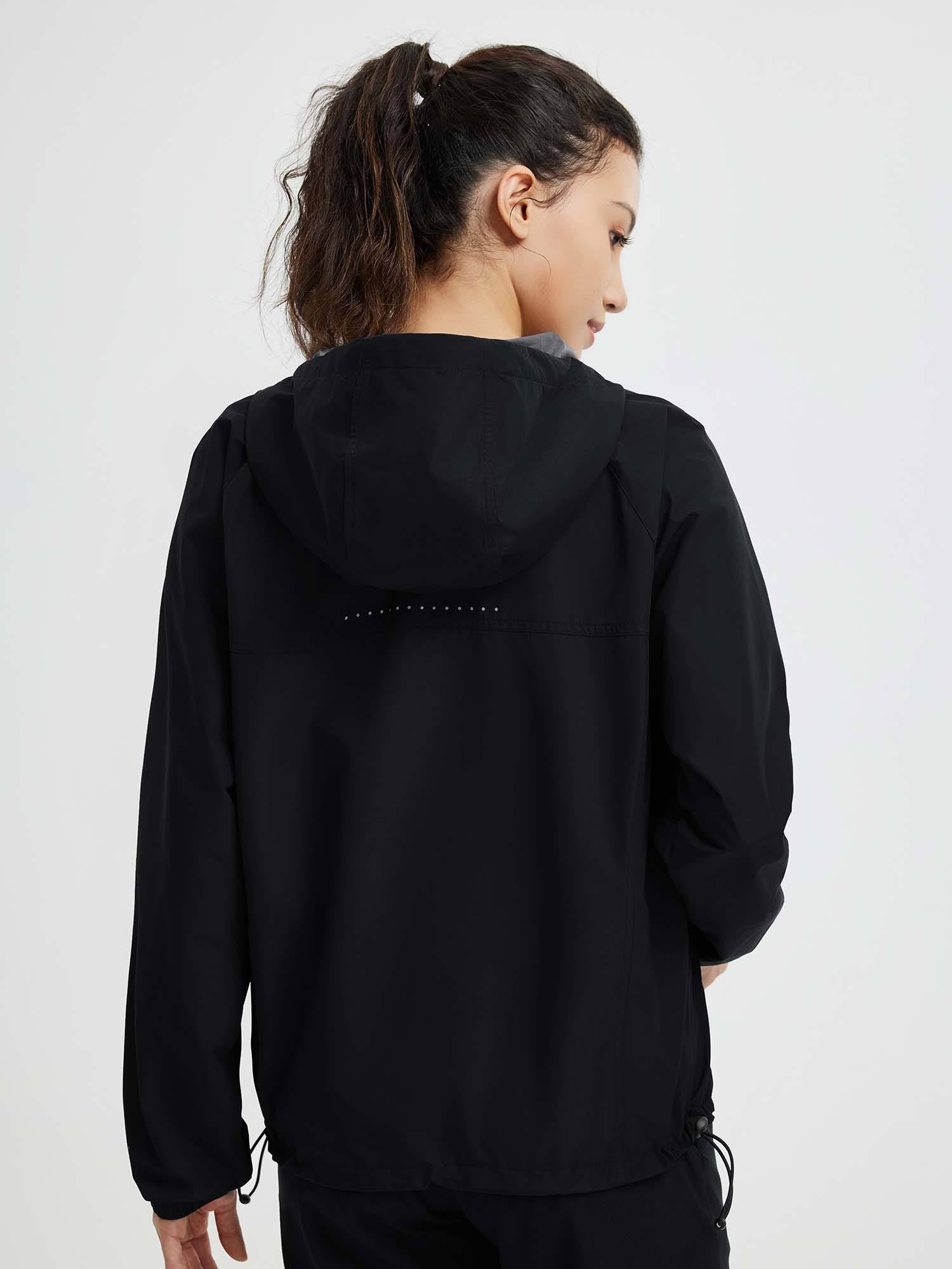 Black outdoor packable windbreaker jacket, back view with reflective dots.