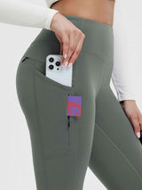 Olive green 25" fleece-lined yoga leggings showing phone in side pocket & zippered pocket. #color_Dark Gray