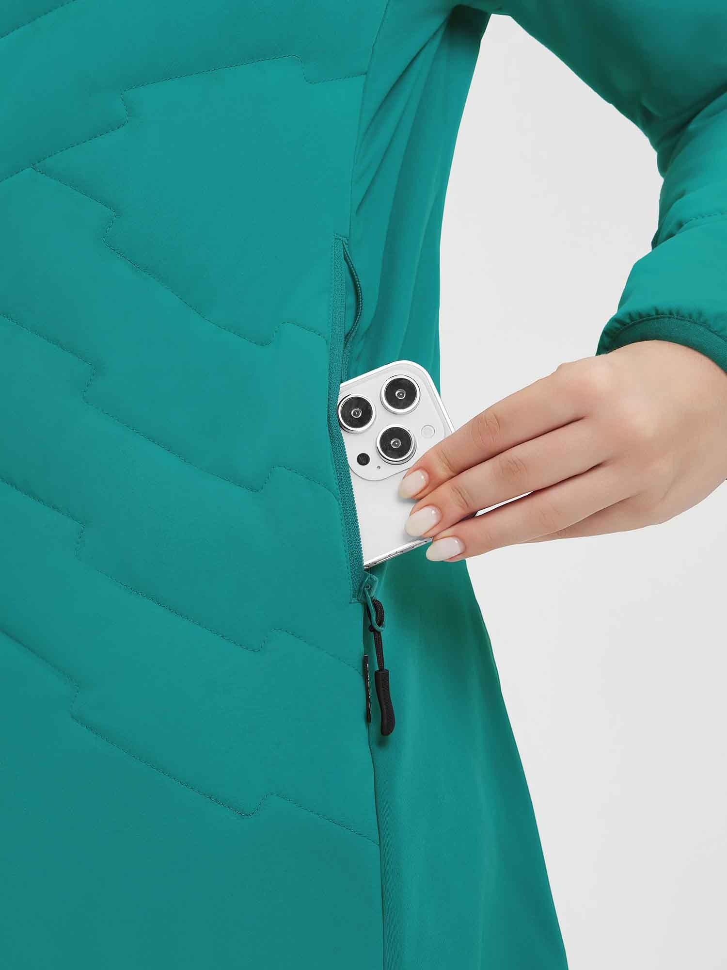 Teal quilted women's mid-length jacket with zippered pocket for phone storage. #Color_Green