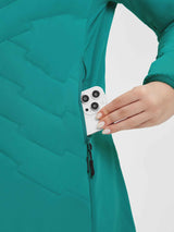 Teal quilted women's mid-length jacket with zippered pocket for phone storage. #Color_Green