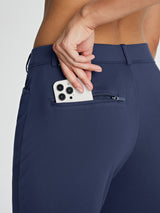 Navy fleece-lined golf pants with zippered phone pocket detail.