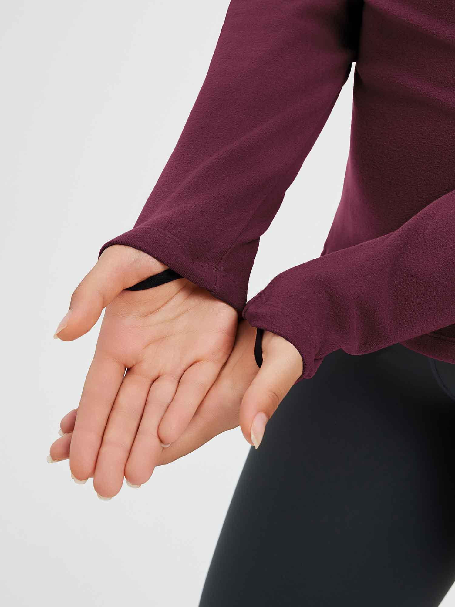 Burgundy fleece running shirt with thumb loop detail on sleeve.