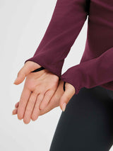 Burgundy fleece running shirt with thumb loop detail on sleeve.