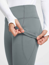 Grey thermal fleece yoga leggings: hand reveals soft, warm fleece lining. #color_Dark Gray