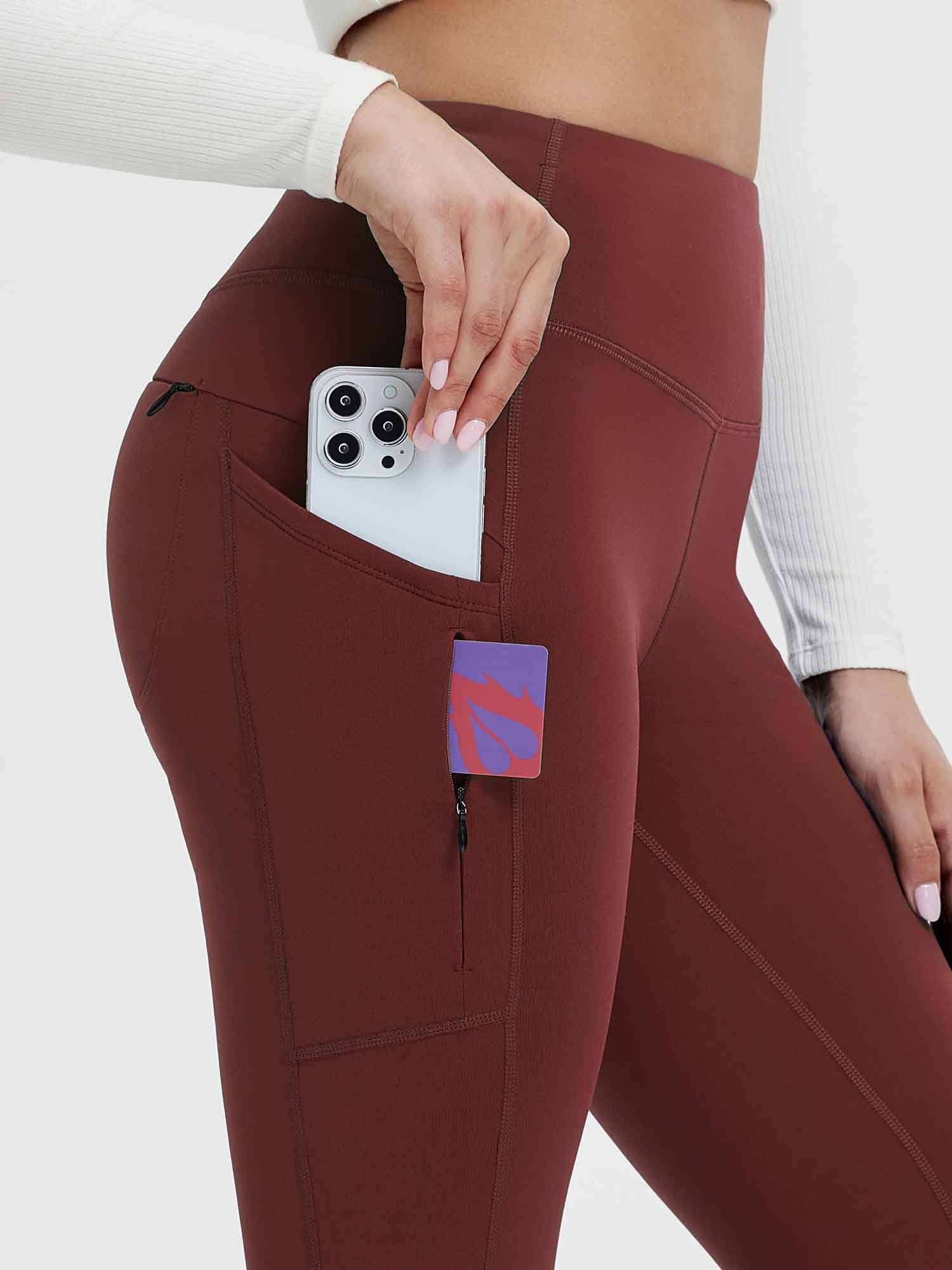 25" maroon fleece-lined yoga leggings with pockets for phone and valuables. #color_Wine Red