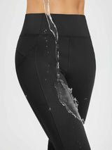 Black women's fleece running pants demonstrate water-resistant fabric. #color_Black