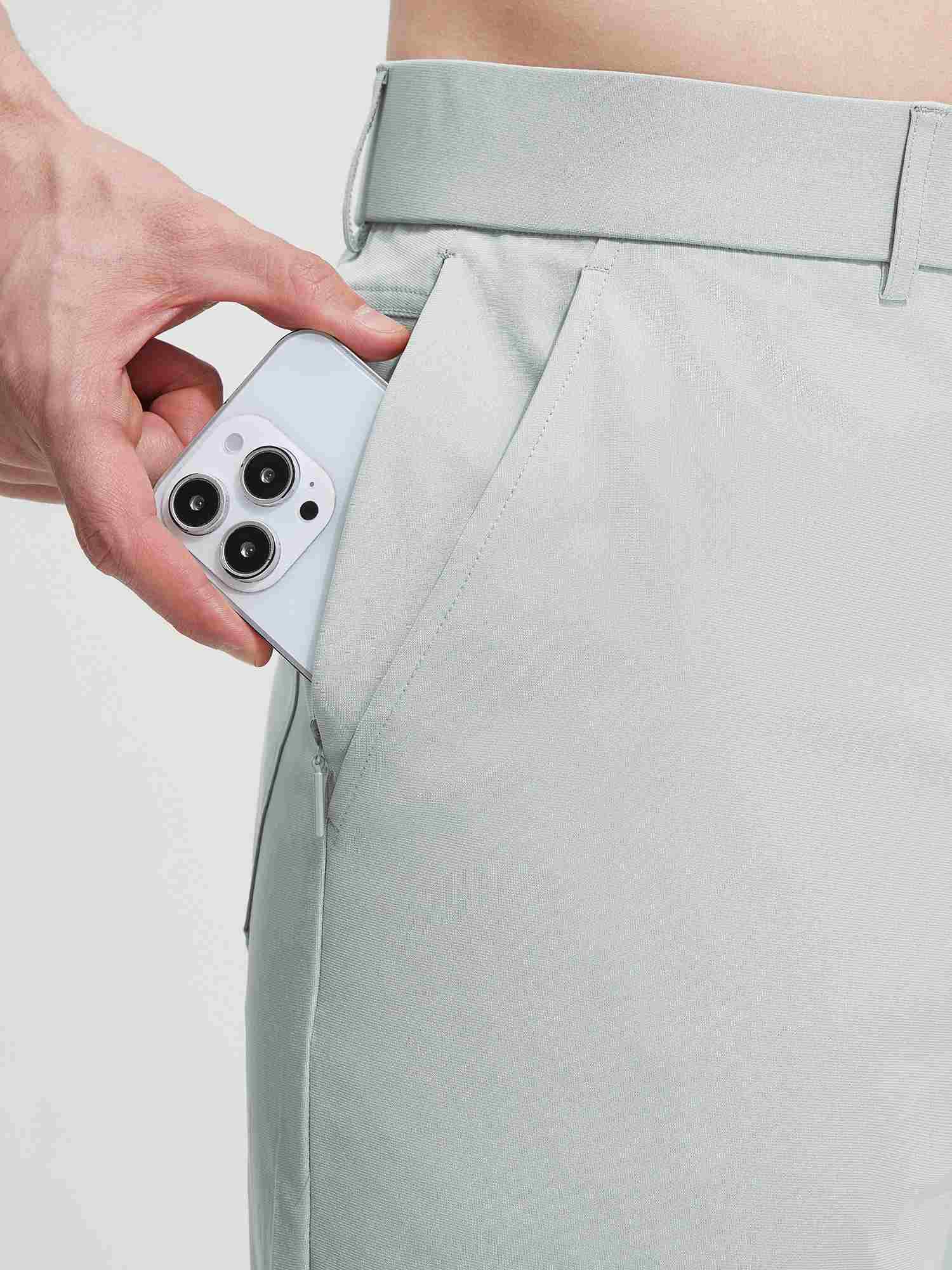 Baleaf UPF 50+ 5-pocket golf pants with zippered pocket holding phone. #color_Light Gray