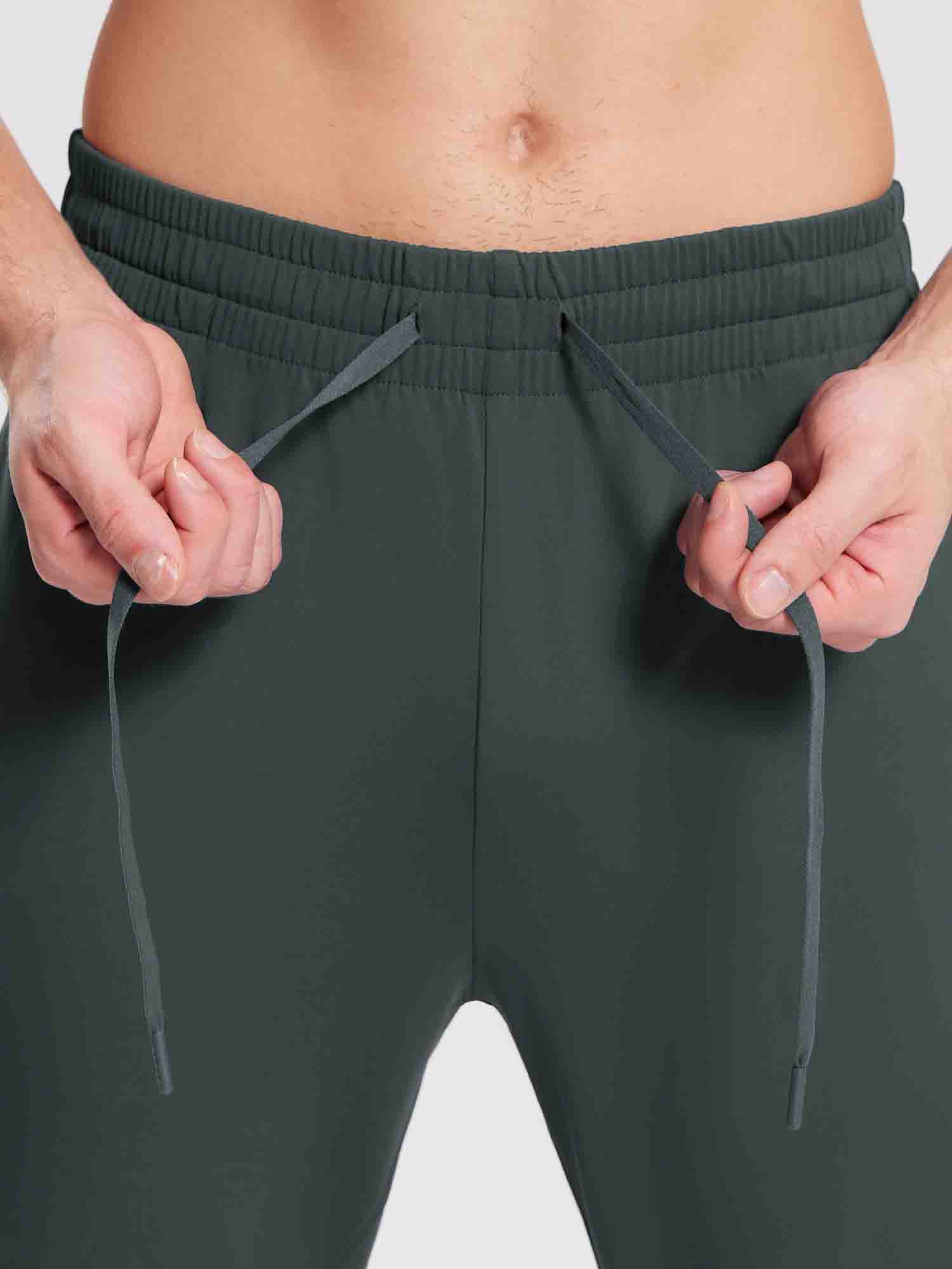 Men's dark grey reflective jogger pants with adjustable drawstring waist.