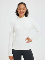 White fleece running half-turtleneck t-shirt with mock neck and flattering seams.