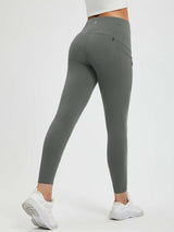 Back view of muted grey fleece-lined yoga leggings with high waistband and zippered pockets #color_Dark Gray