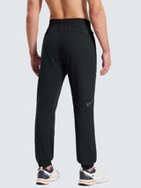 Men's black reflective fleece jogger pants, back view with cuffed ankles. #color_Black