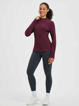 Burgundy fleece half-turtleneck long-sleeve running shirt with thumb loops, 90% polyester.