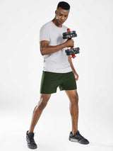 Dark green men's 5" running shorts on athletic model holding dumbbell.