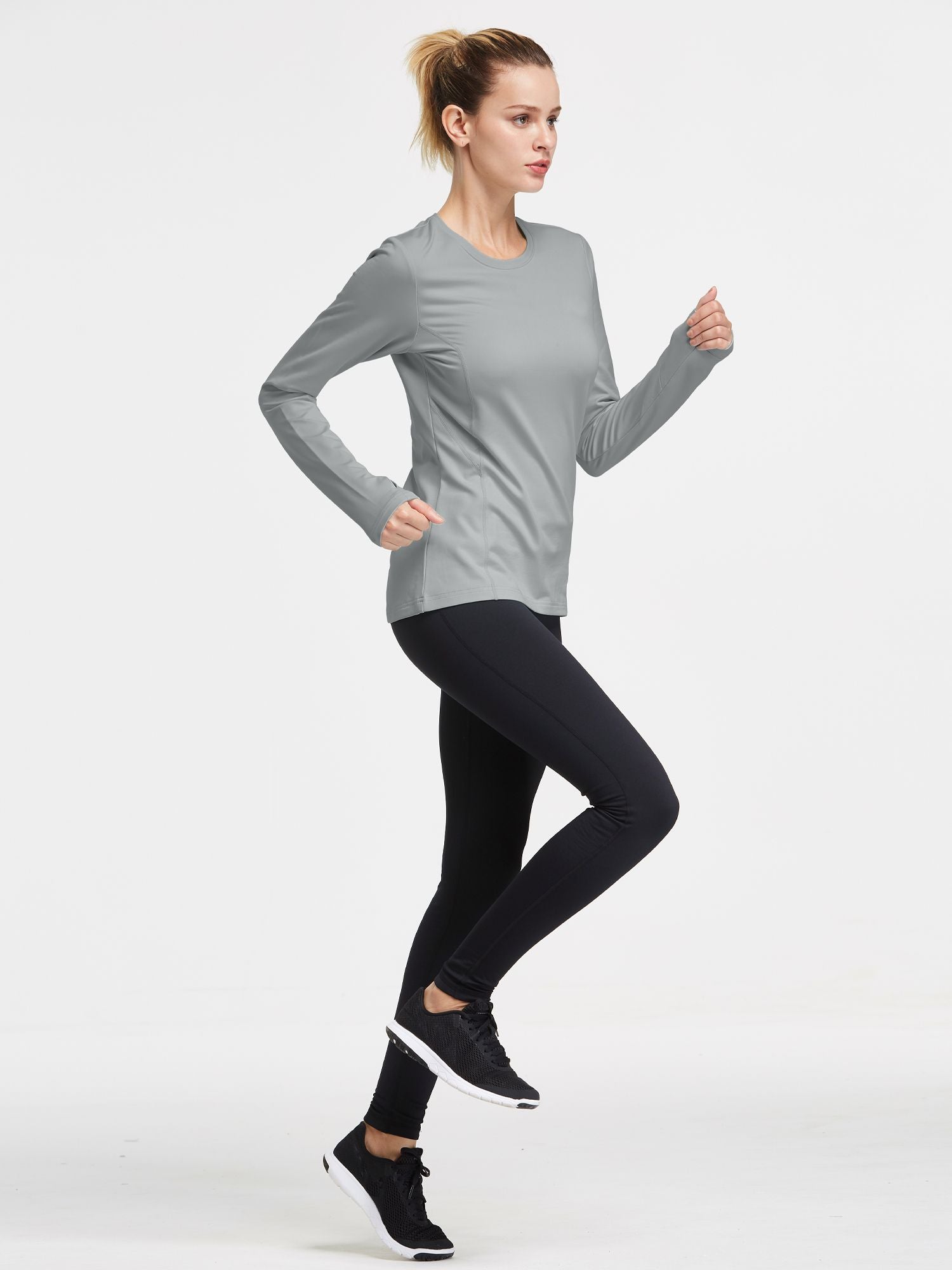 Grey thermal fleece crew pullover with thumbholes, on woman running in black leggings. #color_Light Gray