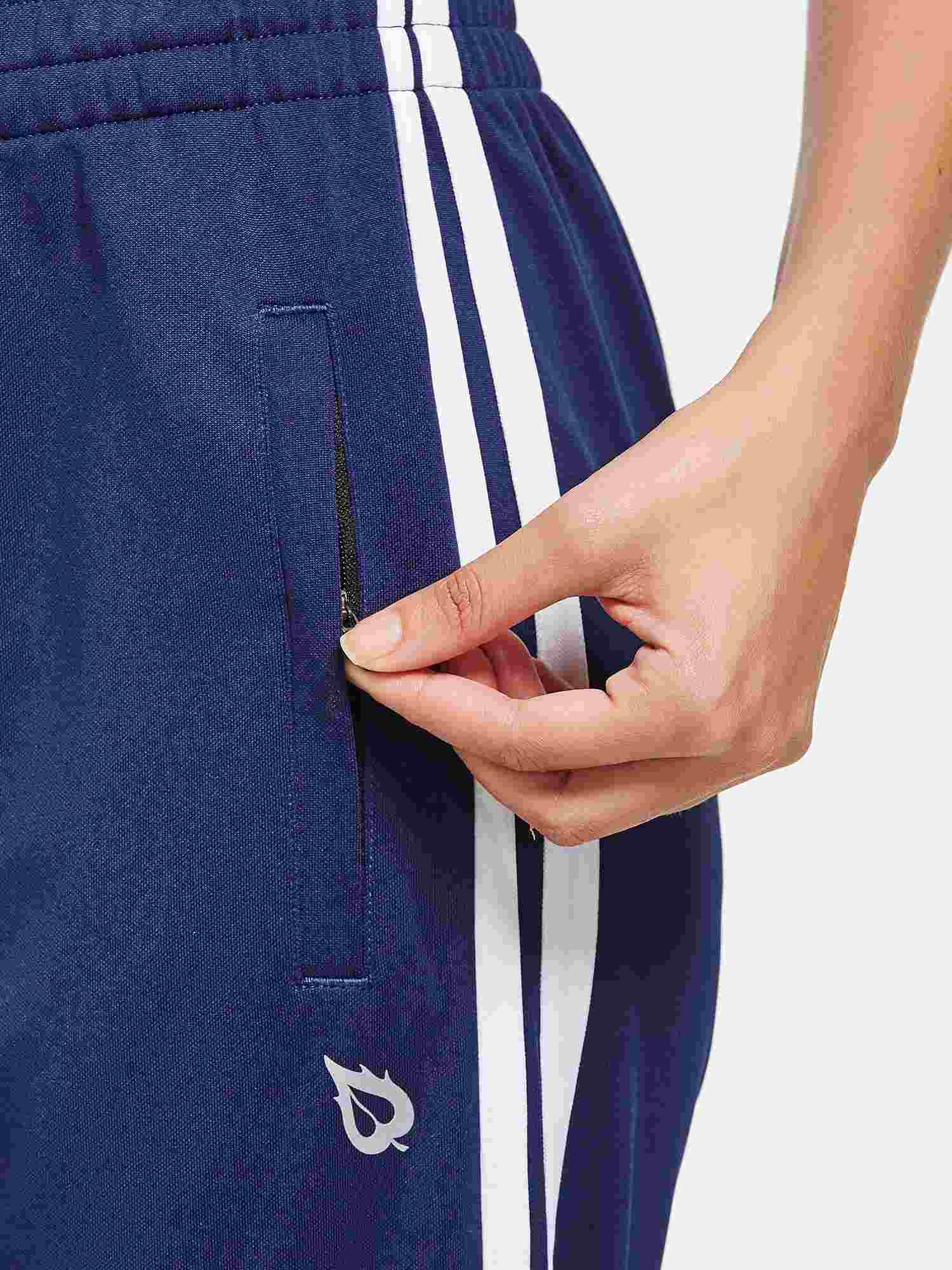 Navy straight-leg running pants with zippered side pocket and white stripe detail.