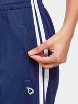 Navy straight-leg running pants with zippered side pocket and white stripe detail.