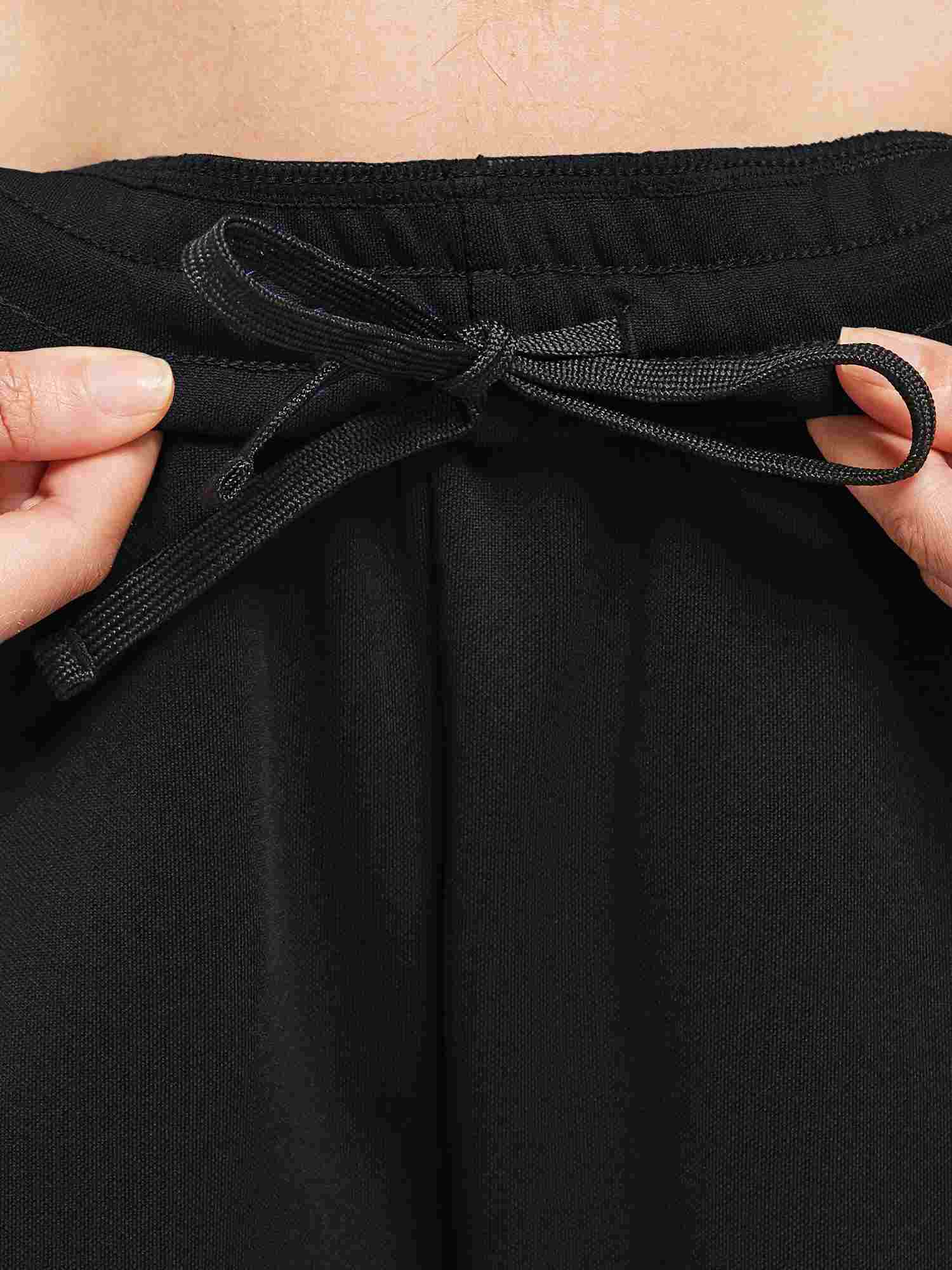 Black knit running pants adjustable drawstring waistband detail. #color_Black/White
